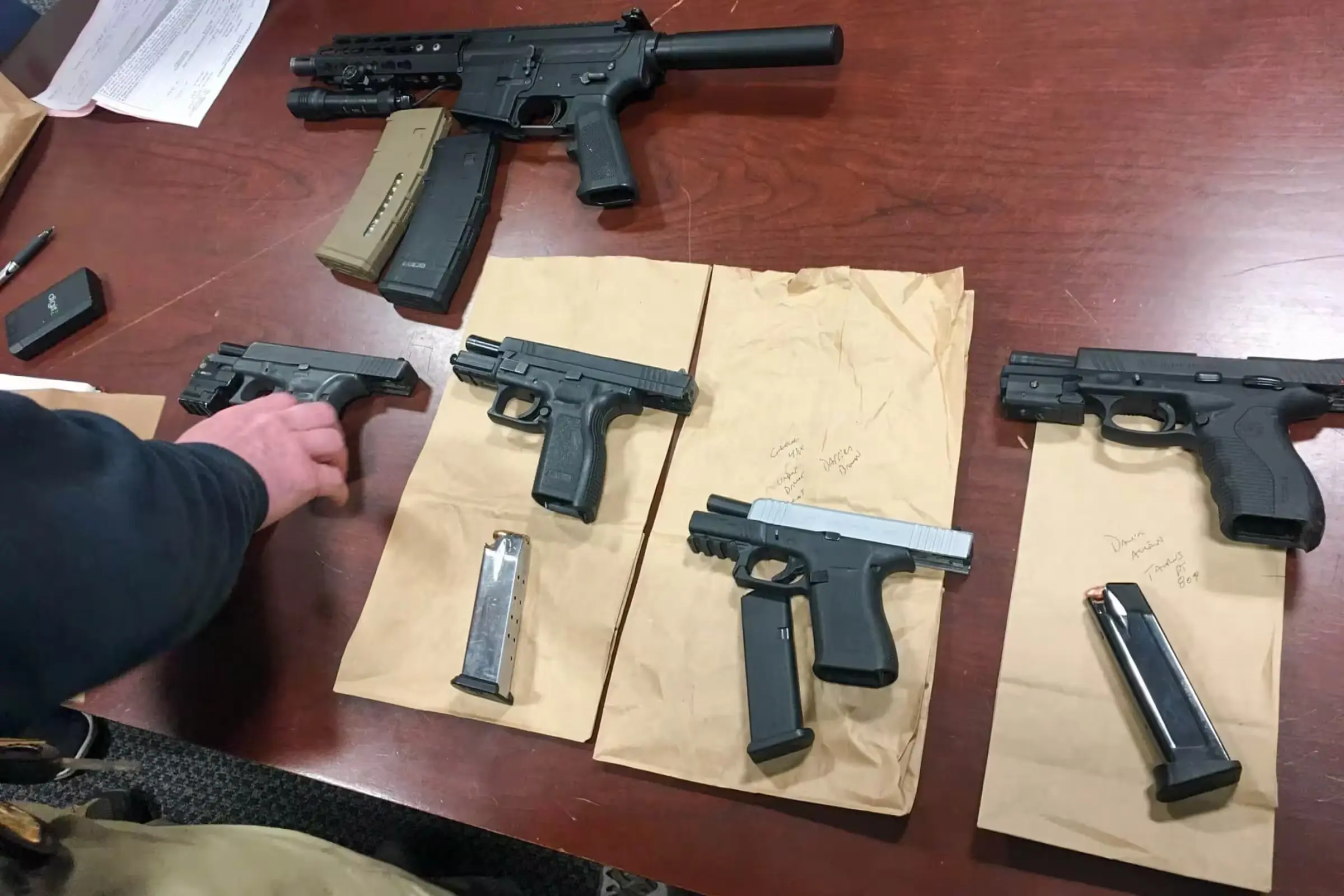 Many pistols on table