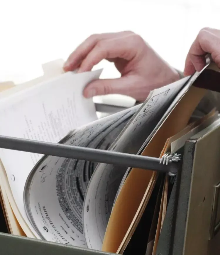 A hand leafing through pages