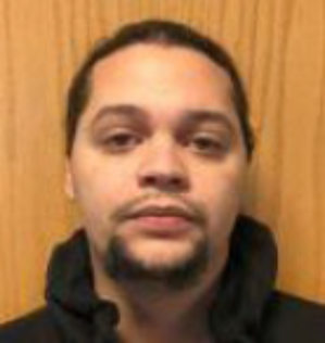 Male fugitive Erric Roman in black outfit